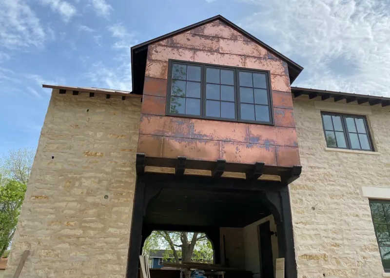 Copper metal panel facade on a stone building for Skylight Installation in Makakilo